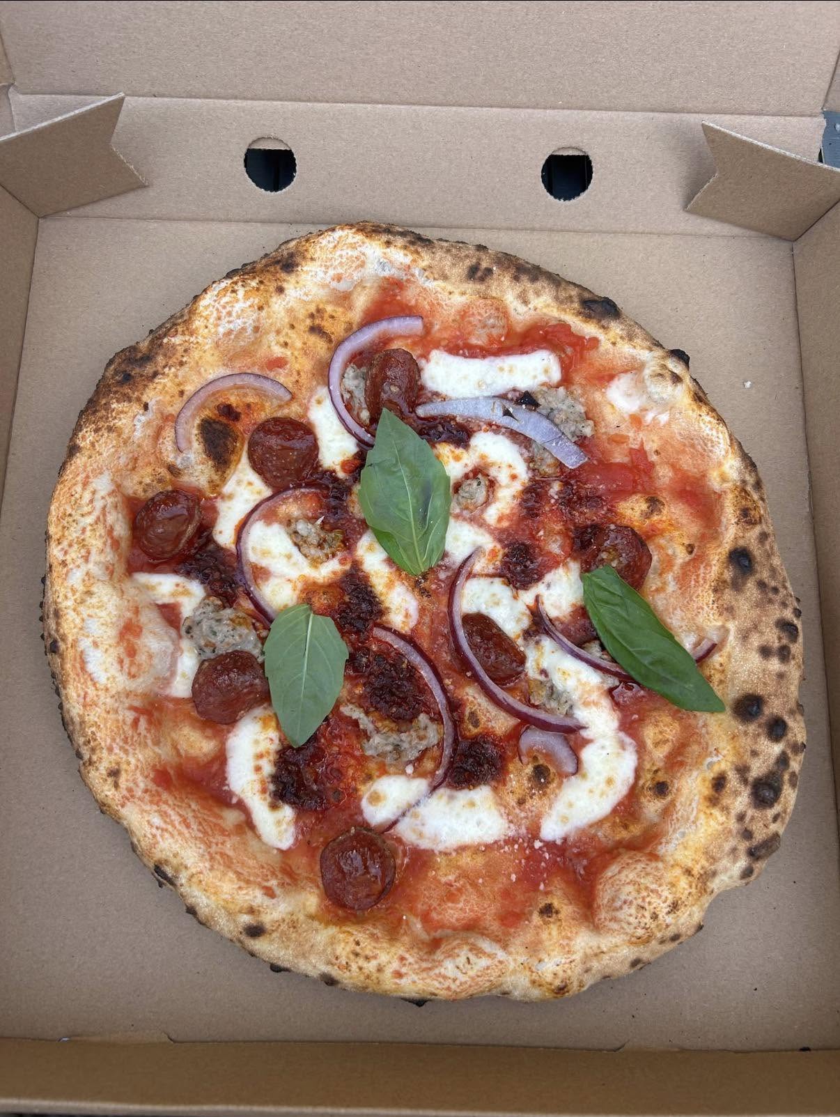 JJ's Pizzeria pizza in a takeaway box