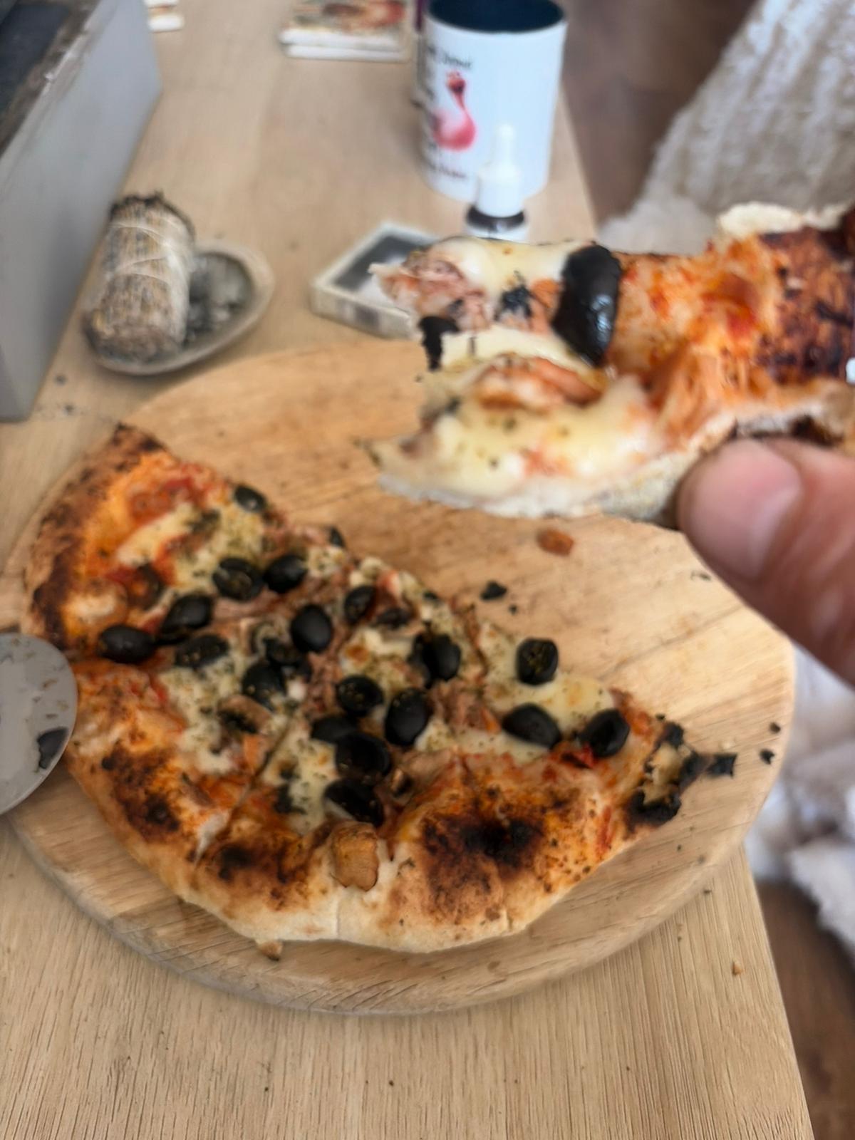 Guest eating a JJ's Pizzeria pizza