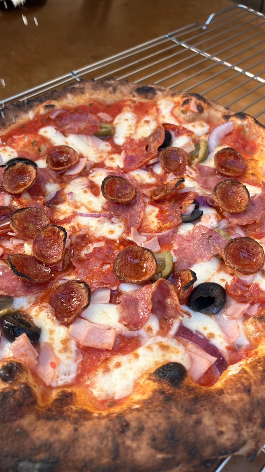 Fresh JJ's Pizzeria pizza on a tray